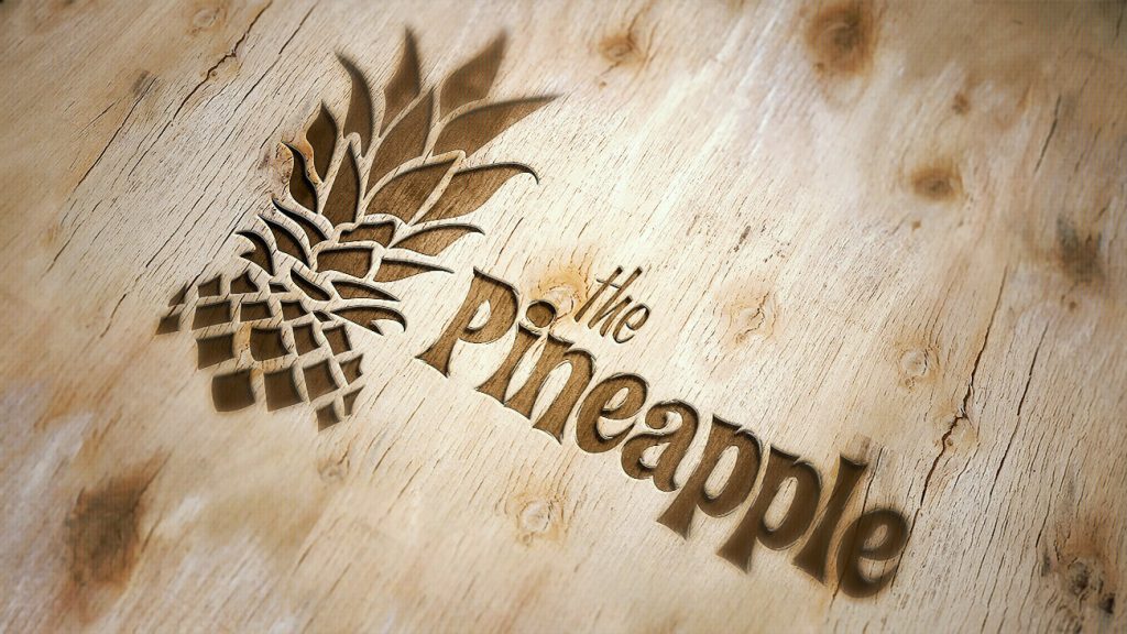 Pineapple logo embossed in wood